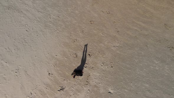 Aerial View of Shadow Play Young Gymnast Woman (Wears Black Sweater and Leggings) Practices Head