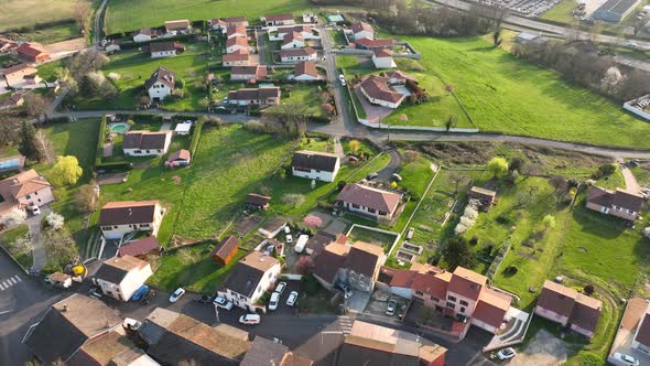 Aerial View of Suburban Landscape with Private Homes Between Green Fields in Quiet French