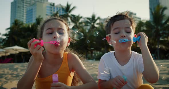 Happy Children Playing with Soap Bubbles