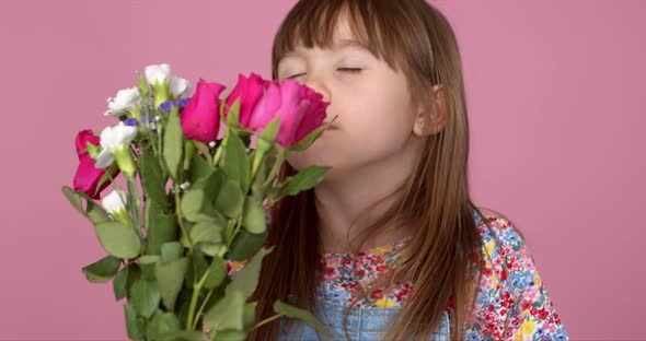 Cute Young Adorable Girl Holding and Smell Bouquet of Fresh Flowers