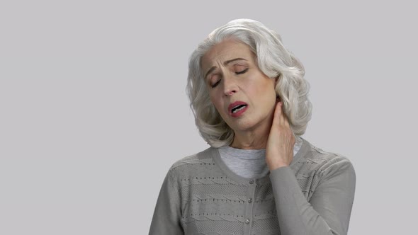 Old Lady Touching Her Neck Because of Pain