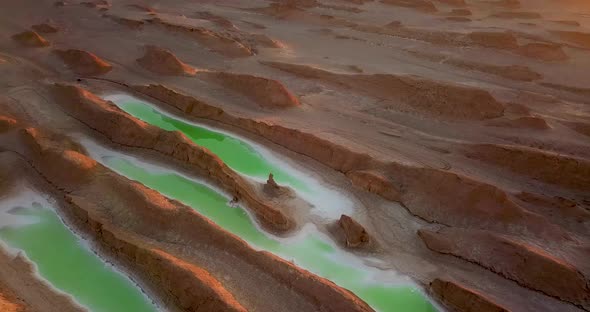Camping beside a green salt lake in middle of a wonderful hot desert at sunset daytime