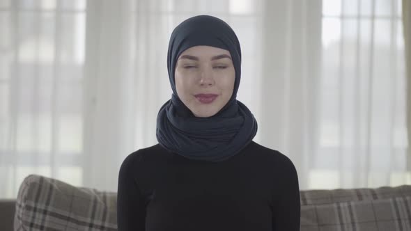 Portrait of Independent Young Muslim Woman Looking Serious Confident at Camera Wearing Traditional