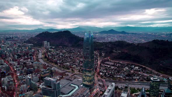 Aerial orbit of the Costanera tower with the Mapocho river and the bridges that connect the smog fre