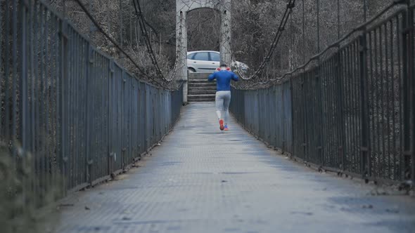 Strong Male Runner with Big Red Headphones and Blue Shirt Going for Training, Walking Slow