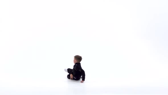 Little Boy Is Dancing a Modern Dance on the White Background in Black Leather Jackets and Jeans