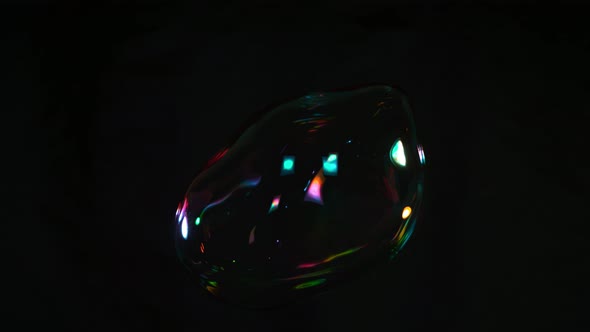 Super Slow Motion Shot of Flying and Cracking Colorful Soap Bubble Isolated on Black at 1000 Fps