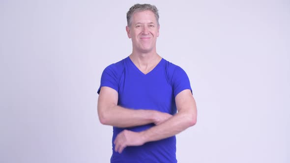 Happy Mature Man Smiling Against White Background