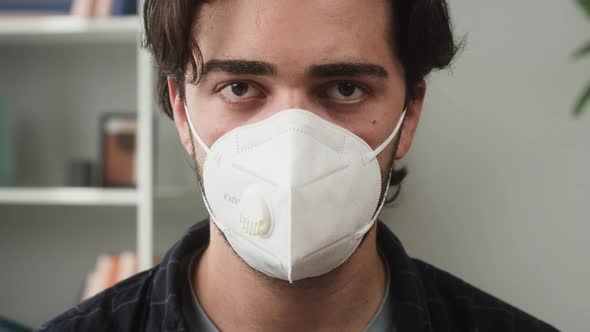 Young Brunette Man Wearing Protective Mask Portrait Guy with Beard Looking in Camera Posing at Home