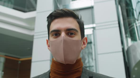 Young Businessman in Mask Posing for Camera in Office Center