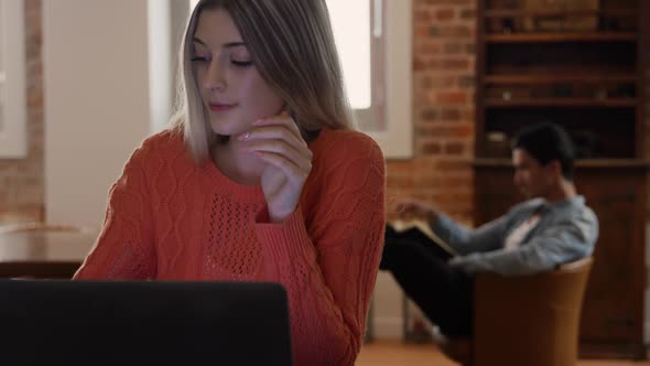 Caucasian woman concentrated and working in her house