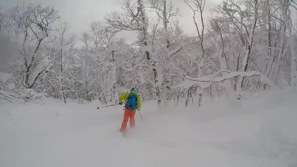 Young man skier skiing in the mountains on fresh powder.