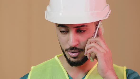 Close Up Shot of Young Hispanic Man Engineer Construction Foreman Builder in Special Safety Helmet