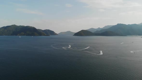 Jet Skis in the Sea on the Background of Beautiful Islands. Aerial Shot 
