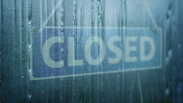 Rain Hitting Store Window With Closed Sign