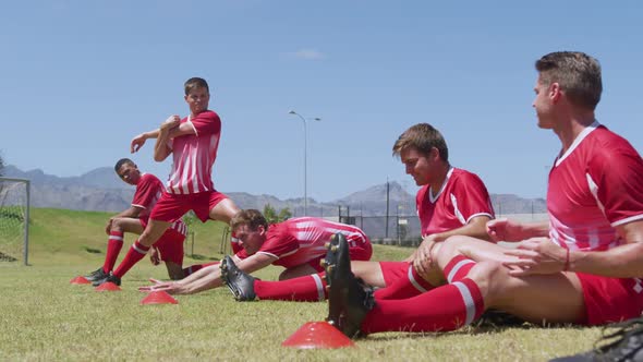 Soccer players stretching before training