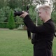 Male Photographer Takes Photos on a Professional Camera Outdoors in Park - VideoHive Item for Sale