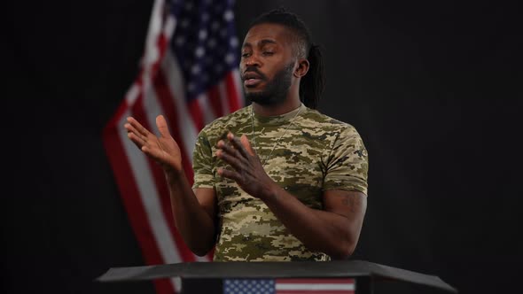 Confident African American Soldier Standing at Tribune Answering Public Question