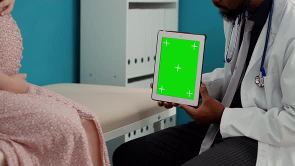 Male Medic Working with Greenscreen on Tablet at Examination