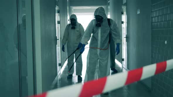 People Work in Hallway, Disinfecting It During Coronavirus Pandemic.