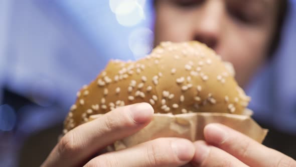 Hungry Man with Appetite Eating Hamburger Close Up