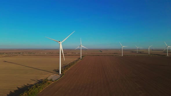 Remote Windfarm in Large Field at Sunrise