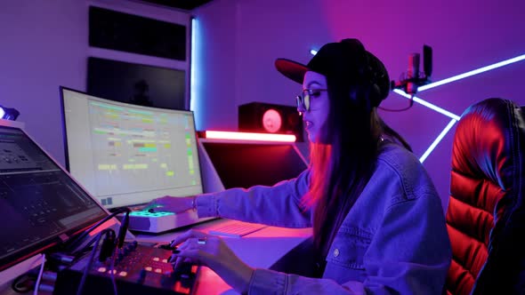 Musician Woman is Focused on Working in the Recording Studio with Computer and Mixer Creating Music