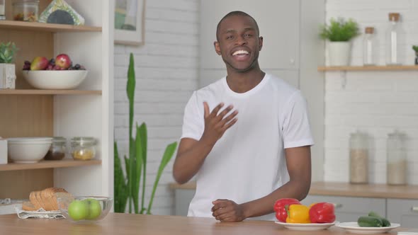 Athletic African Man Doing Video Call While Standing in Kitchen