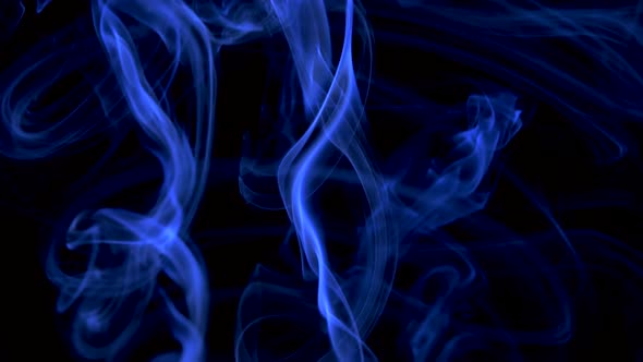 Abstract Smoke Cloud in the Form of a Spiral. Blue Smoke Slowly Floating Through Space Against Black