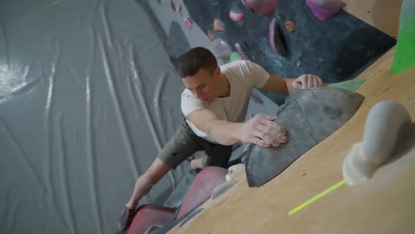 Climber Training on a Climbing Wall Practicing Rockclimbing View From Above