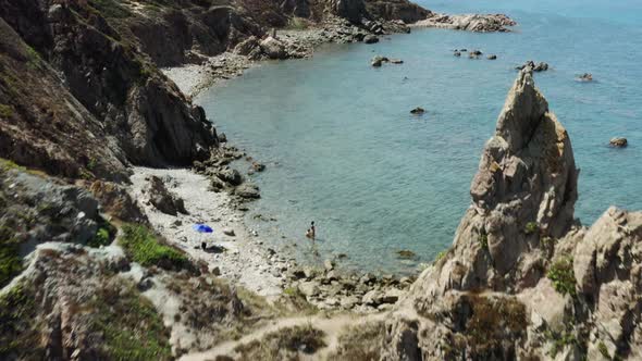 aerial shot of an isolated rocky beach on the Italian Sardinia island