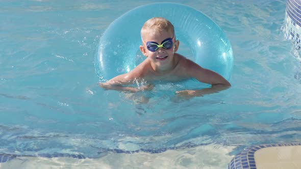 Portrait Smiling Boy in Swimming Pool Child in Swimming Glasses and Swimming Circle