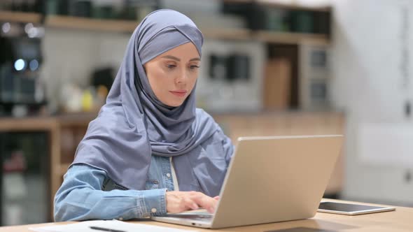 Arab Woman with Laptop Smiling at the Camera
