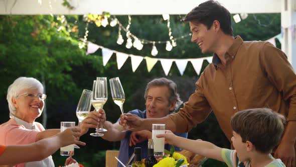 Family eating outside together in summer