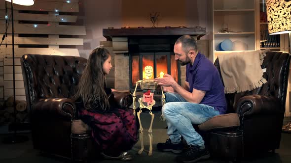 Dad Telling Her Daughter About the Function of Ribs in Human Skeleton