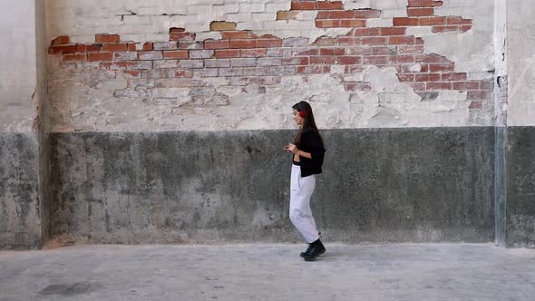 Woman with headphones dancing to music she is listening to