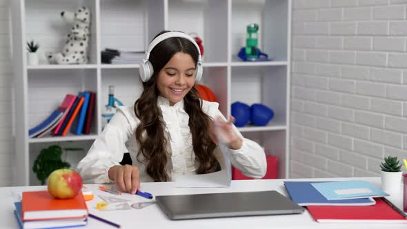 Happy Teen Girl in Uniform and Earphones Enjoy Music After Lesson End Closing Laptop Communication