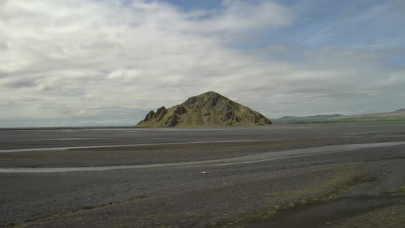 Aerial view around a lonely peak, in wilderness of Iceland - low, circling, drone shot