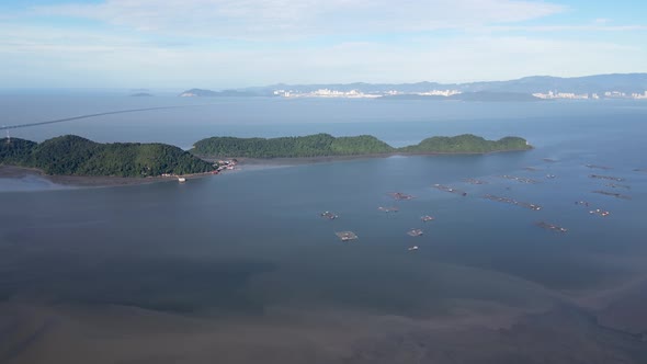 Aerial fly toward Pulau Aman and Pulau Gedung in blue sunny day