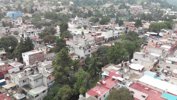 Aerial panoramic view of Barrio La Concepción in southern Mexico City. Drone descending slowly with