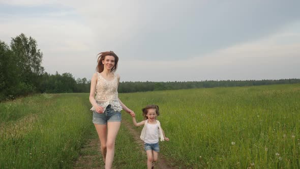 Young Mother in Short Shorts Run with Her Daughter a Child