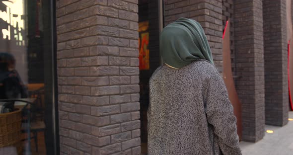 Rear View of Muslim Woman Going on the Street