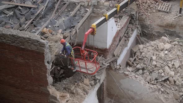 Demolition of Old Abandoned House Workman in Orange Helmet at Crane Basket Destroy Wooden Roof with