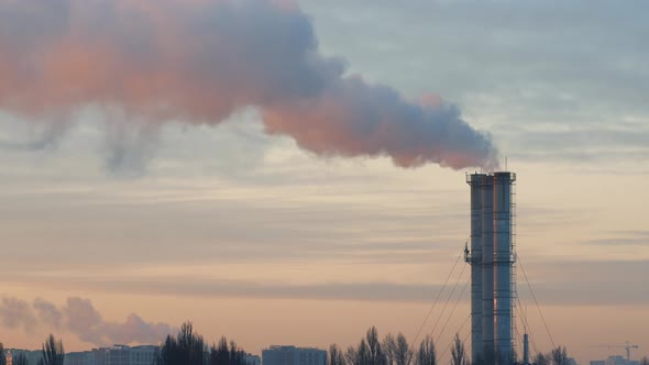 Industrial Area in the Morning at Dawn. Power Lines and Smoking Pipes of a Thermal Power Plant