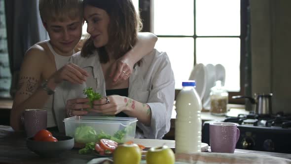 Young Lesbian Women are Talking and Hugging While Preparing Dinner in Home Interior