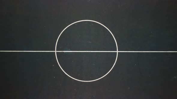 Aerial shot revealing a basketball court,  camera facing down