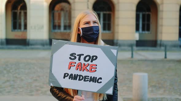 Young Woman in Protective Mask Protesting Against Fake Pandemic