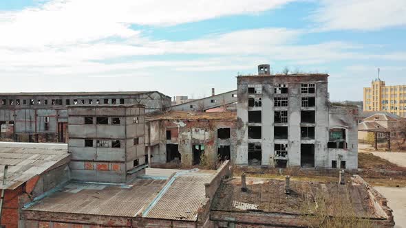 Aerial view of an old factory ruin and broken windows. Old industrial building for demolition.