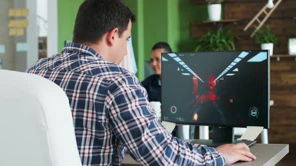 After a Hard Day at the Office a Young Businessman Playing Video Games on His Computer