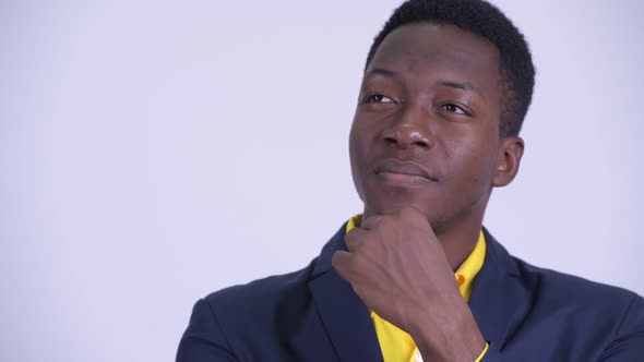 Face of Young Happy African Businessman in Suit Thinking